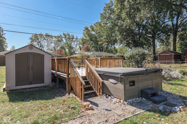 wooden terrace featuring a hot tub, a storage unit, and a lawn