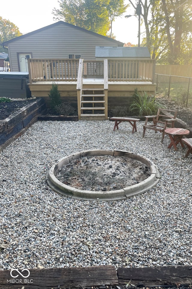 view of yard with a deck and a fire pit