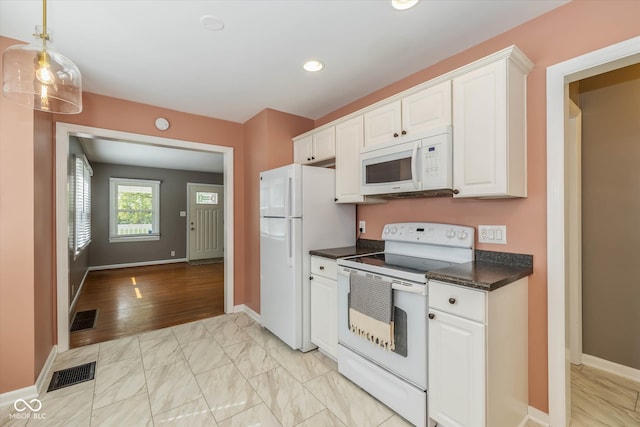 kitchen featuring white cabinetry, light hardwood / wood-style floors, and white appliances