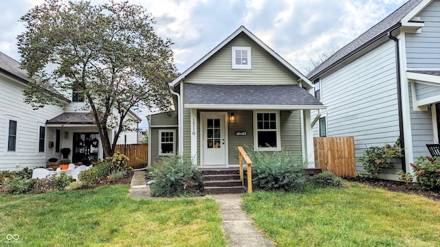 bungalow-style home featuring a front lawn and covered porch