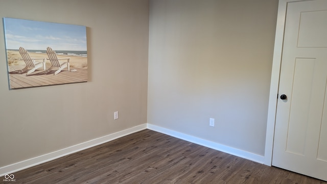 spare room with dark hardwood / wood-style floors