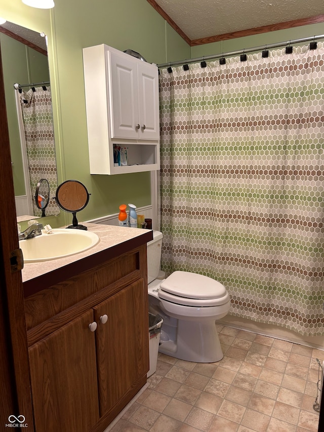 bathroom with walk in shower, crown molding, a textured ceiling, toilet, and vanity