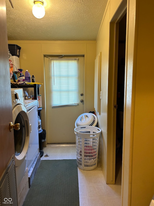 washroom with separate washer and dryer and a textured ceiling