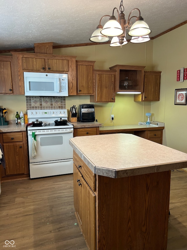 kitchen with a textured ceiling, white appliances, dark wood-type flooring, a center island, and hanging light fixtures