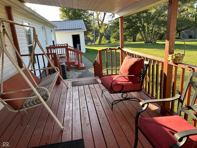 wooden deck featuring a lawn