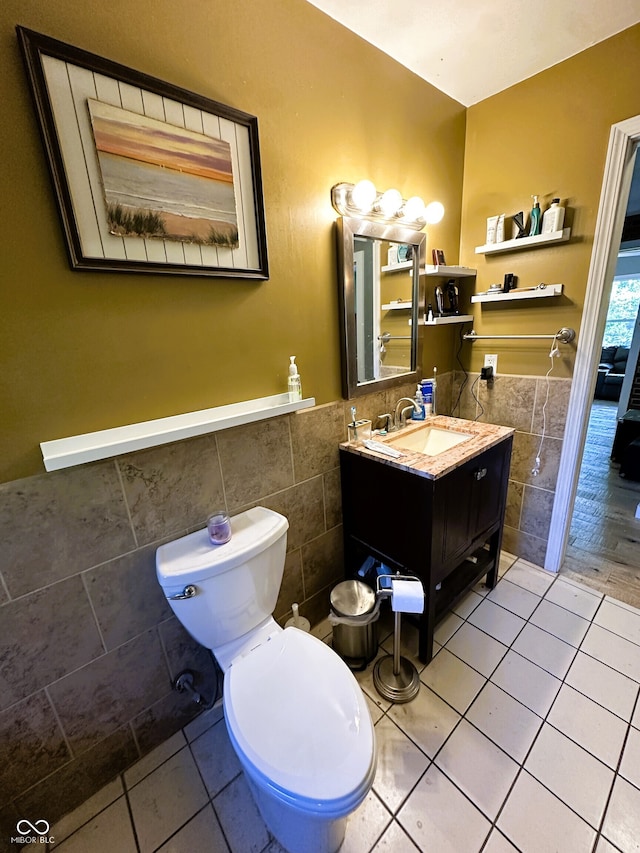 bathroom featuring tile walls, vanity, wood-type flooring, and toilet