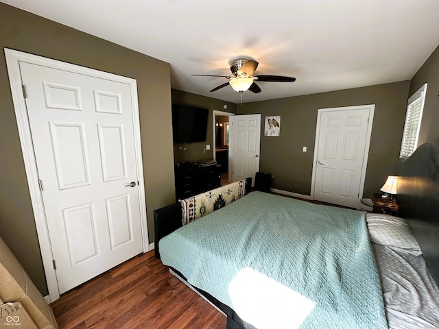 bedroom with dark hardwood / wood-style flooring and ceiling fan