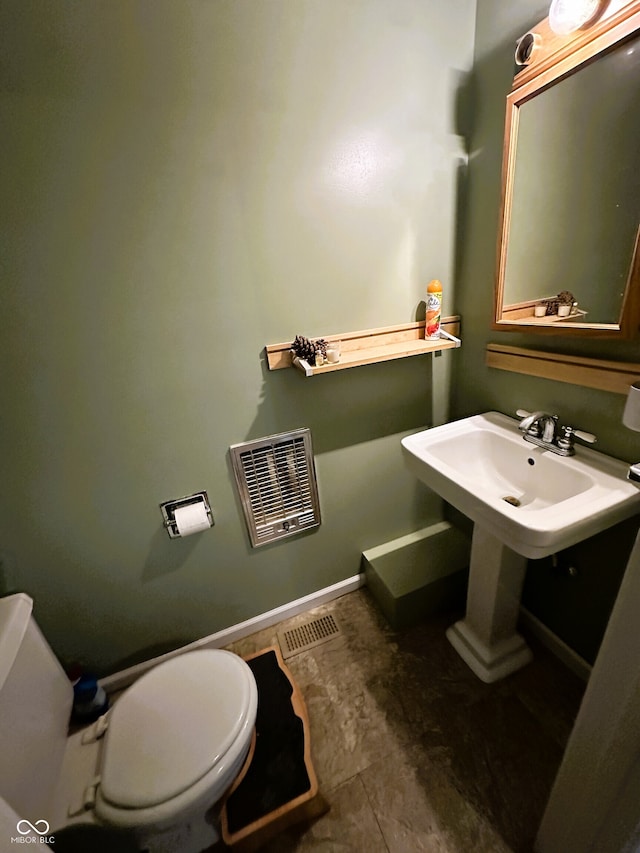 bathroom featuring toilet, sink, and tile patterned floors