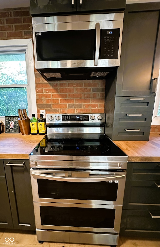 kitchen with wood counters and appliances with stainless steel finishes