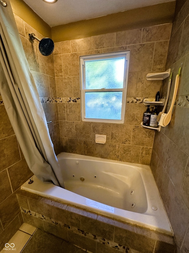 bathroom with shower / bath combo with shower curtain and tile walls