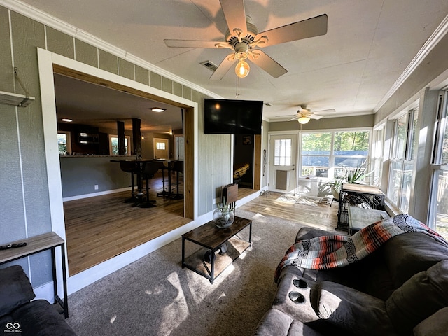 living room with crown molding, hardwood / wood-style flooring, and ceiling fan