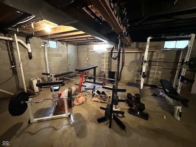 exercise room featuring concrete floors and plenty of natural light