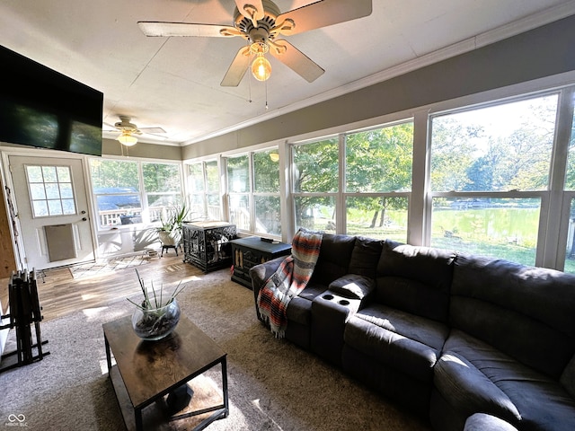 living room featuring crown molding and ceiling fan