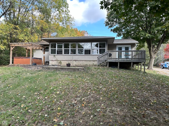 rear view of house with a wooden deck and a pergola