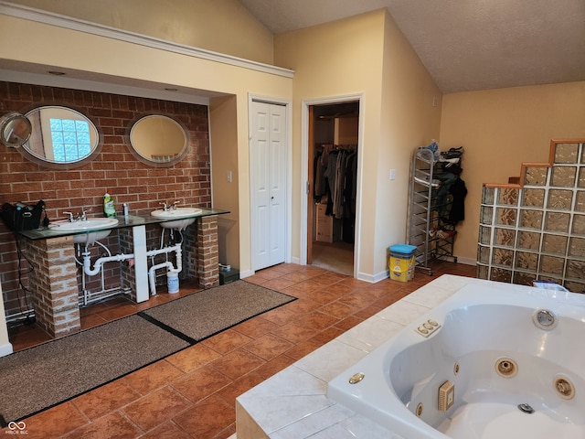 bathroom with a bathtub, vaulted ceiling, and sink