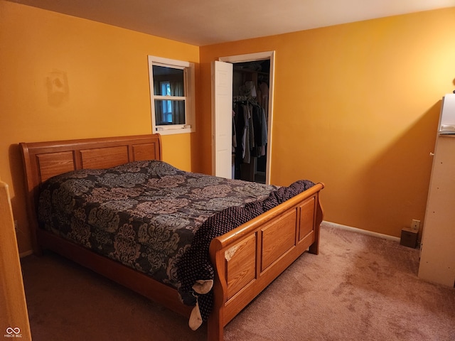 bedroom featuring a spacious closet, light colored carpet, and a closet