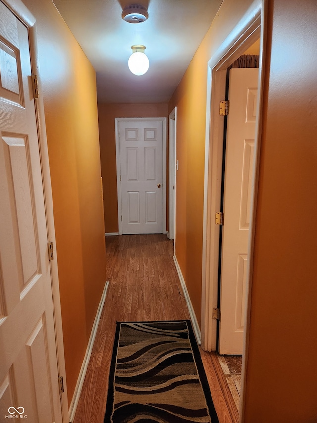 hallway with light hardwood / wood-style flooring