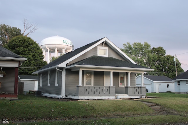 view of front facade with a porch and a front lawn