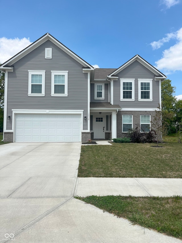 view of front of house featuring a front yard and a garage