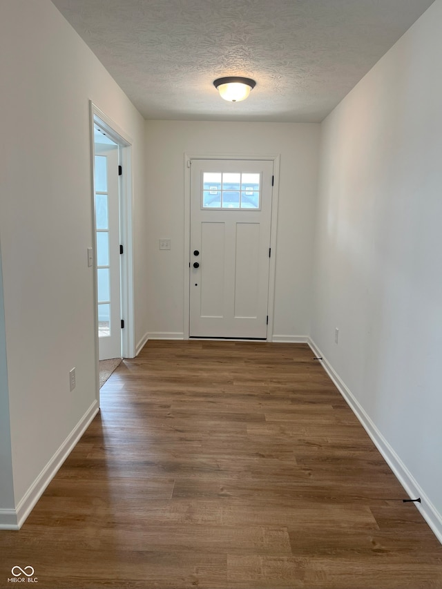 entryway featuring a textured ceiling and dark hardwood / wood-style floors