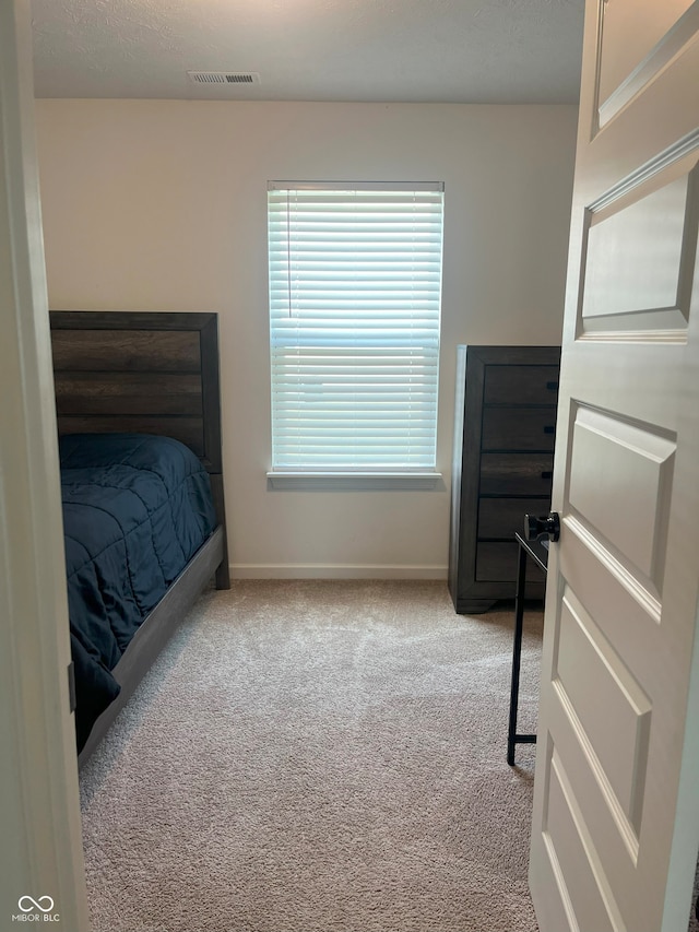 bedroom featuring light colored carpet