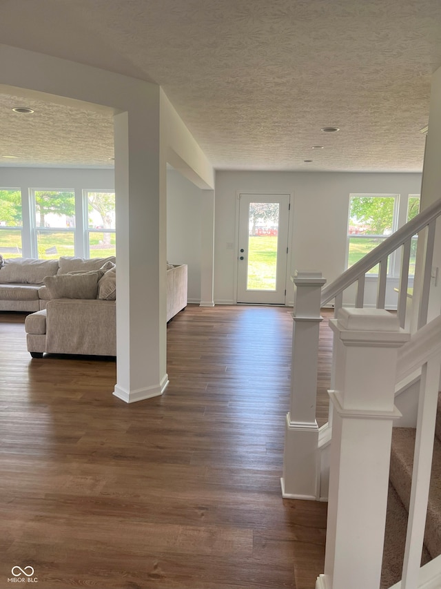 entryway featuring a textured ceiling and dark hardwood / wood-style floors