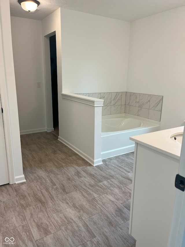 bathroom featuring vanity and a tub