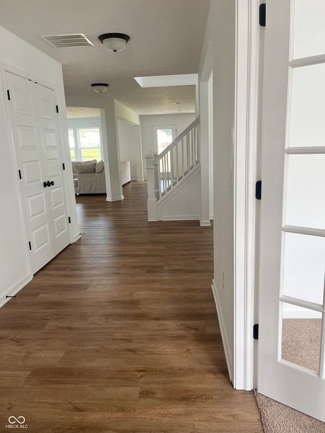 hall with dark wood-type flooring