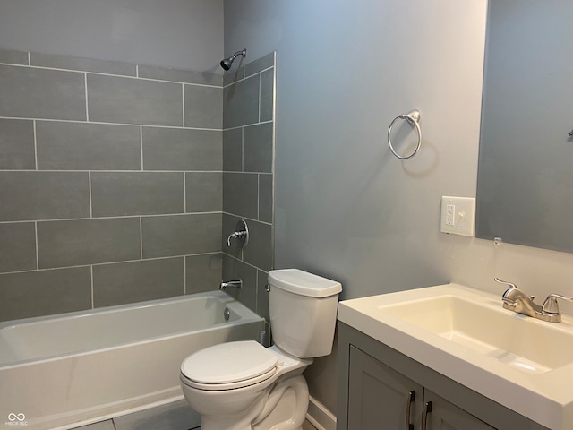 full bathroom featuring tile patterned floors, vanity, toilet, and tiled shower / bath combo