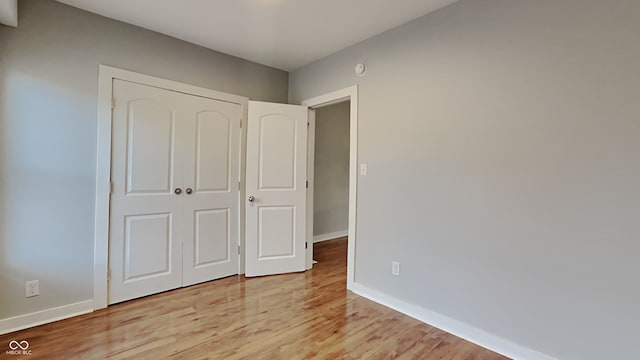 unfurnished bedroom featuring a closet and light hardwood / wood-style floors