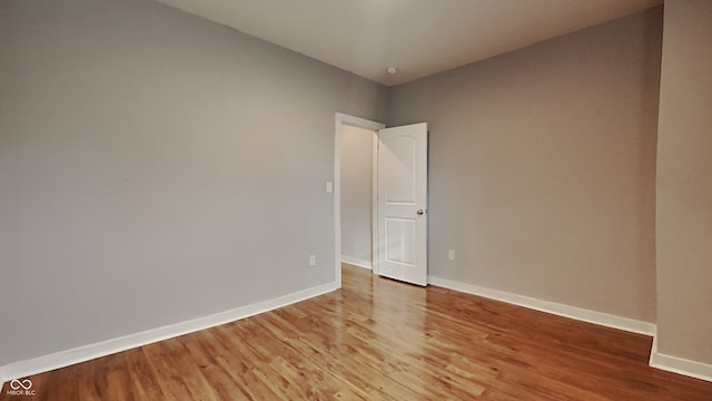 empty room with hardwood / wood-style floors