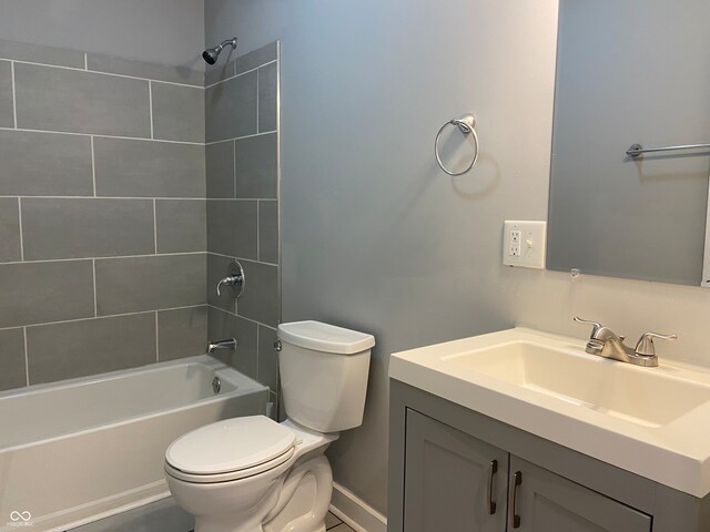 full bathroom featuring vanity, toilet, and tiled shower / bath combo