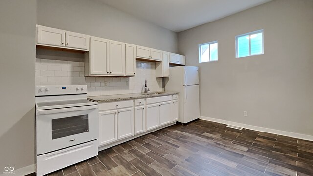 kitchen with dark wood-type flooring, white appliances, sink, and white cabinets