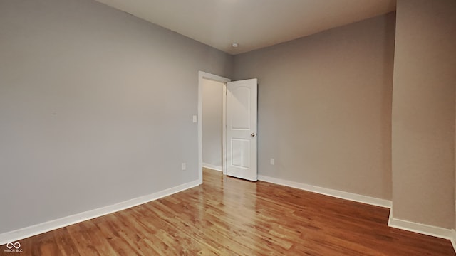 empty room with hardwood / wood-style floors