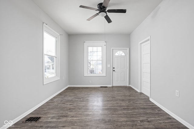 foyer entrance featuring ceiling fan and dark wood-type flooring