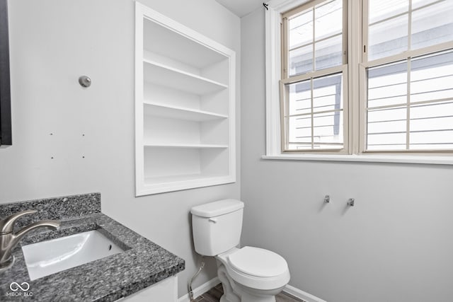 bathroom with vanity, plenty of natural light, and toilet