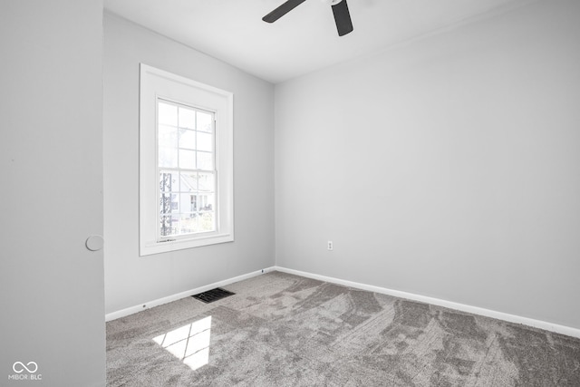 carpeted spare room featuring ceiling fan