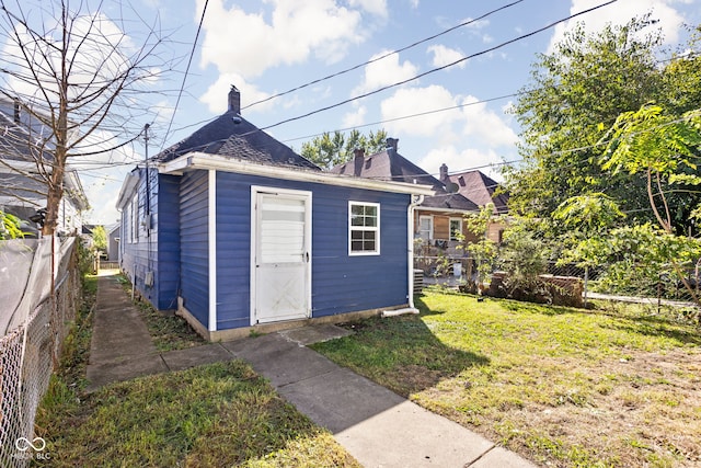 view of outbuilding featuring a lawn