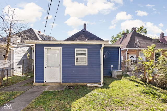 exterior space with a lawn and central AC unit