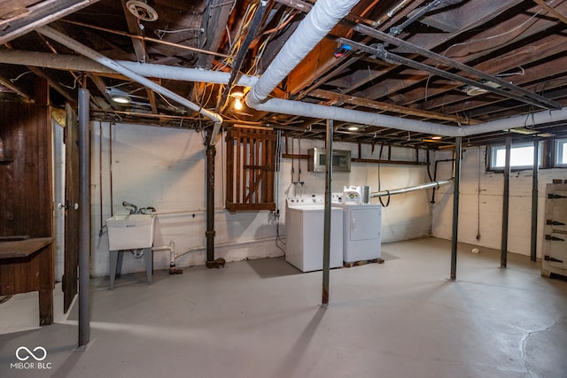 basement featuring sink and separate washer and dryer