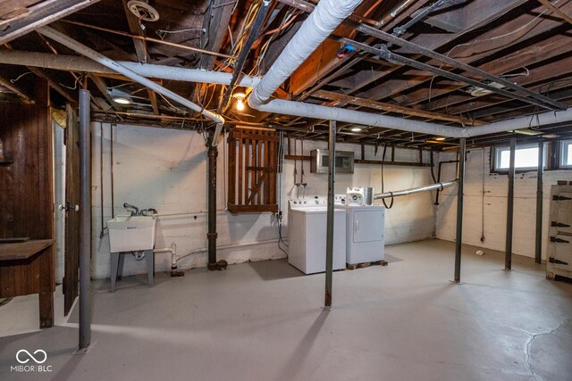below grade area with washer and dryer and a sink