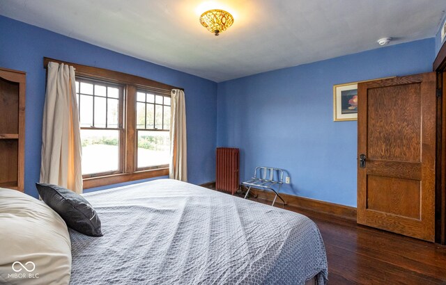 1457 Fairfield Ave, Indianapolis, IN 46205 - bedroom featuring radiator, dark wood finished floors, and baseboards