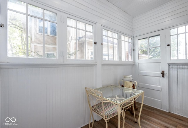 sunroom featuring wood finished floors and french doors