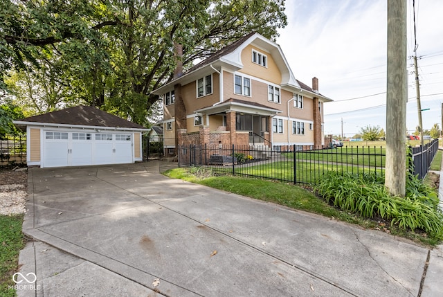 front of property with a front yard, a garage, and an outbuilding