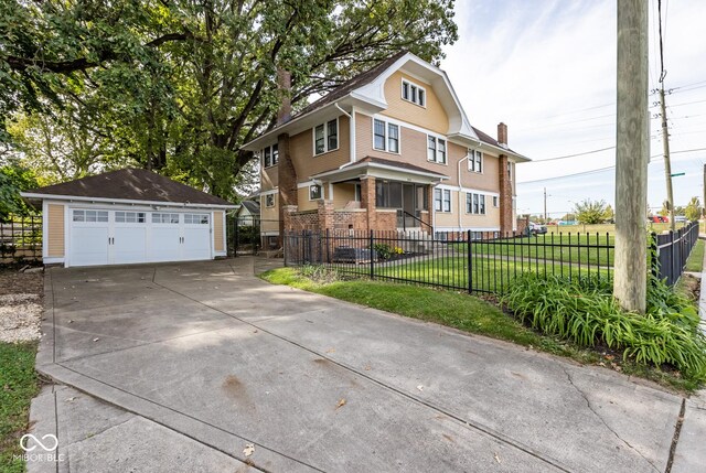 1457 Fairfield Ave, Indianapolis, IN 46205 - traditional style home featuring an outdoor structure, fence private yard, a front yard, and a garage