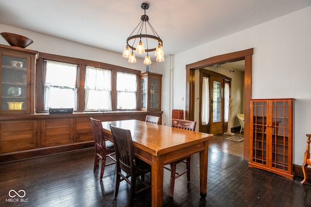 dining room with a chandelier and dark hardwood / wood-style floors