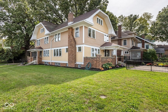 back of house with a chimney, fence, and a lawn