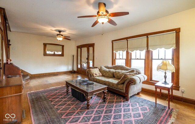 1457 Fairfield Ave, Indianapolis, IN 46205 - living room with wood finished floors, baseboards, ceiling fan, and french doors