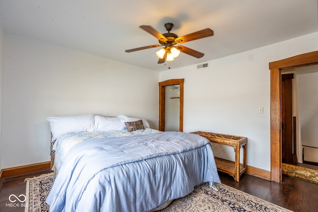 bedroom with dark wood-type flooring and ceiling fan