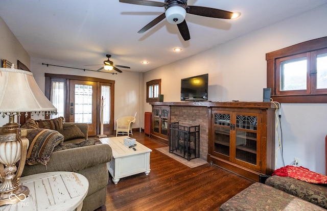 living room with dark wood finished floors, ceiling fan, a brick fireplace, and recessed lighting